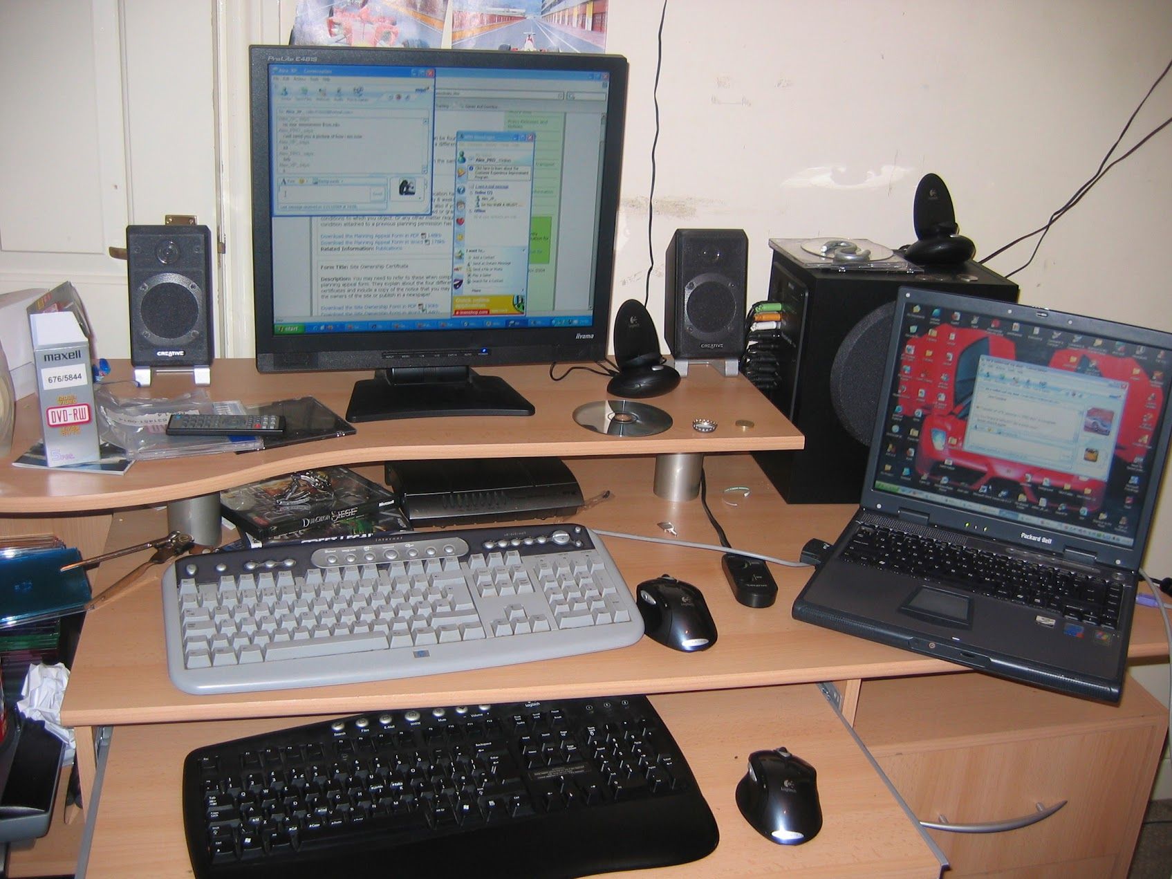 2004 bedroom desk setup: Iiyama CRT with Windows XP, Packard Bell laptop, Creative speakers, two keyboards, Maxell DVD-R spindle