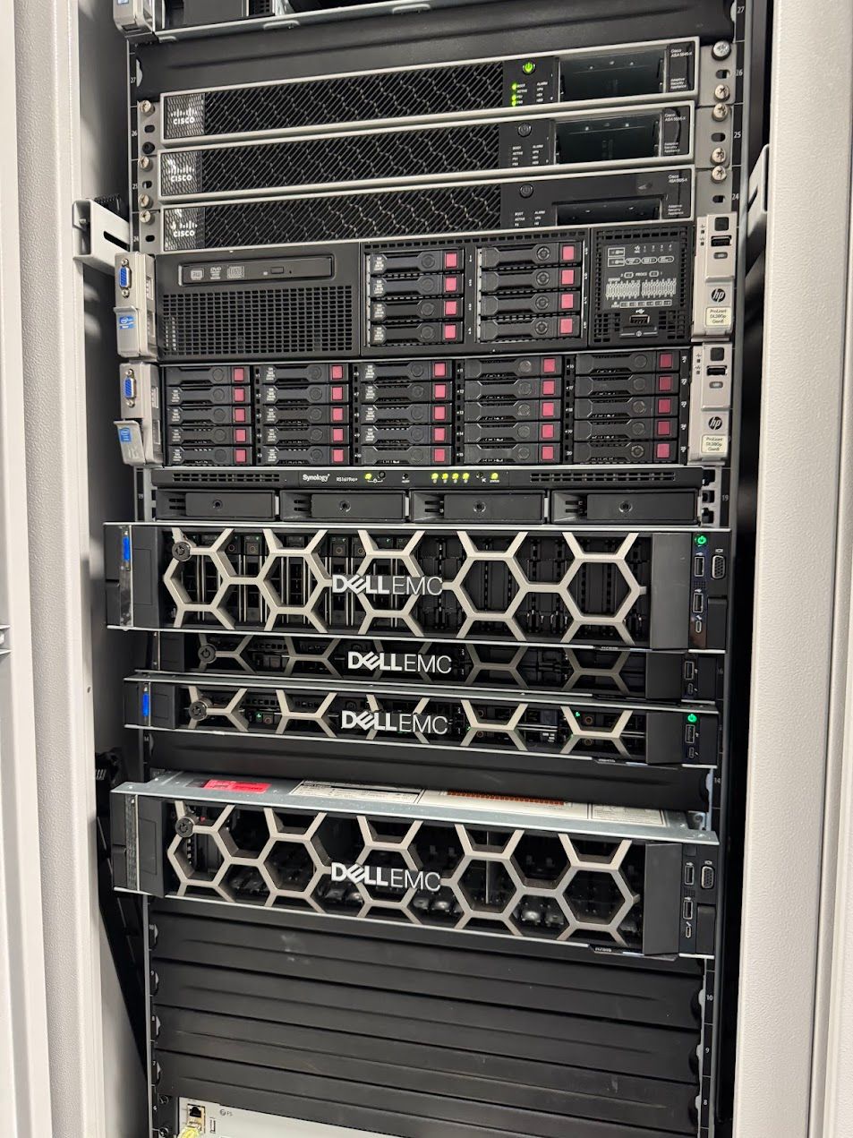 A full production cabinet of rack-mount servers, storage, and networking kit